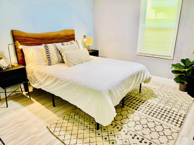 bedroom with wood-type flooring