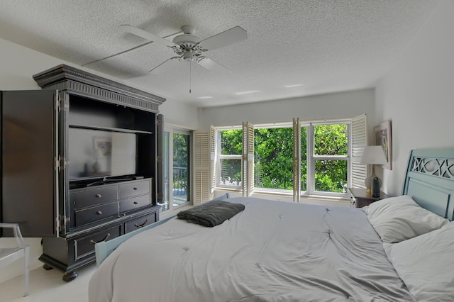 bedroom with a textured ceiling and ceiling fan