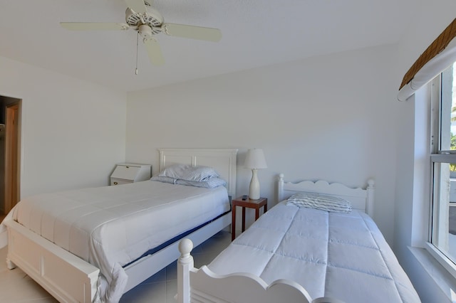 bedroom with ceiling fan and light tile patterned floors