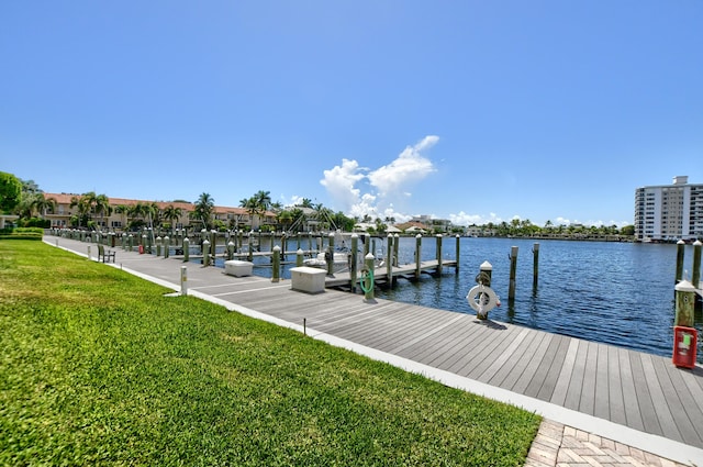 view of dock with central air condition unit, a water view, and a yard