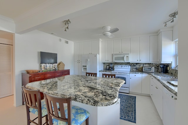 kitchen with light tile patterned floors, track lighting, white appliances, and white cabinets