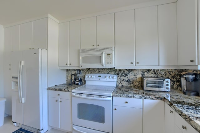 kitchen with white cabinetry, stone counters, and white appliances