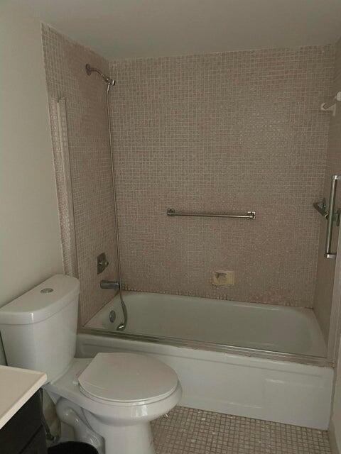 full bathroom with tile patterned flooring, combined bath / shower with glass door, toilet, and vanity