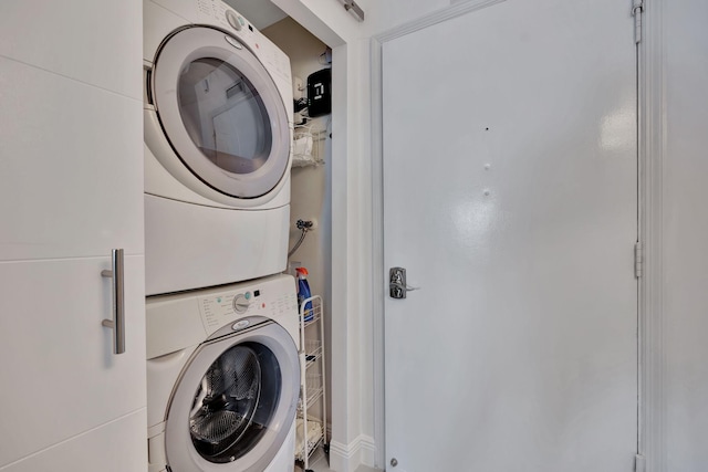 washroom with stacked washing maching and dryer