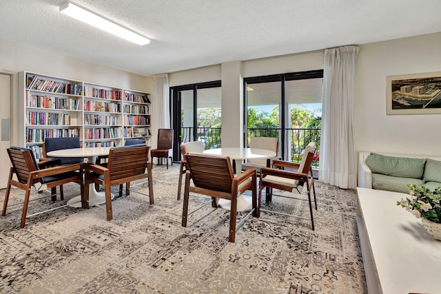 dining area featuring a textured ceiling