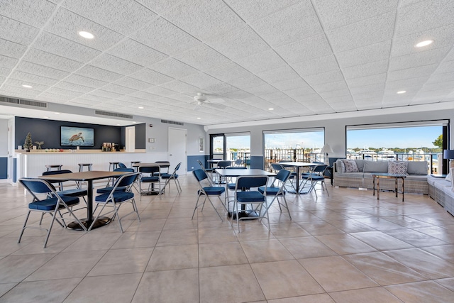 tiled dining space featuring ceiling fan