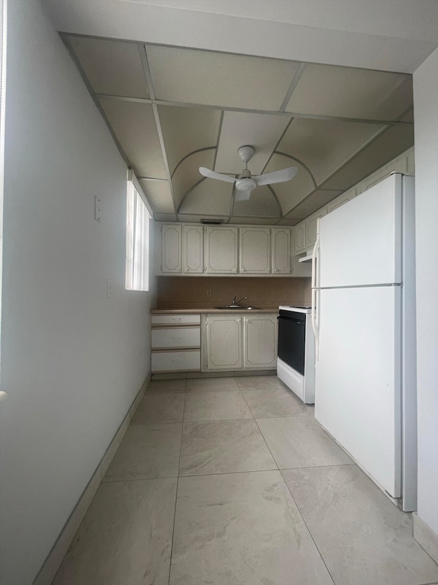 kitchen with ceiling fan, a paneled ceiling, light tile patterned floors, sink, and white appliances