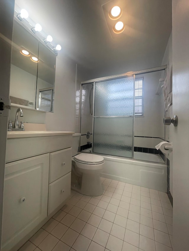 full bathroom with shower / bath combination with glass door, toilet, vanity, and tile patterned floors