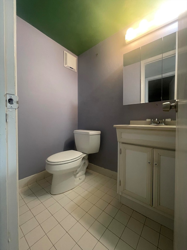 bathroom with tile patterned flooring, vanity, and toilet