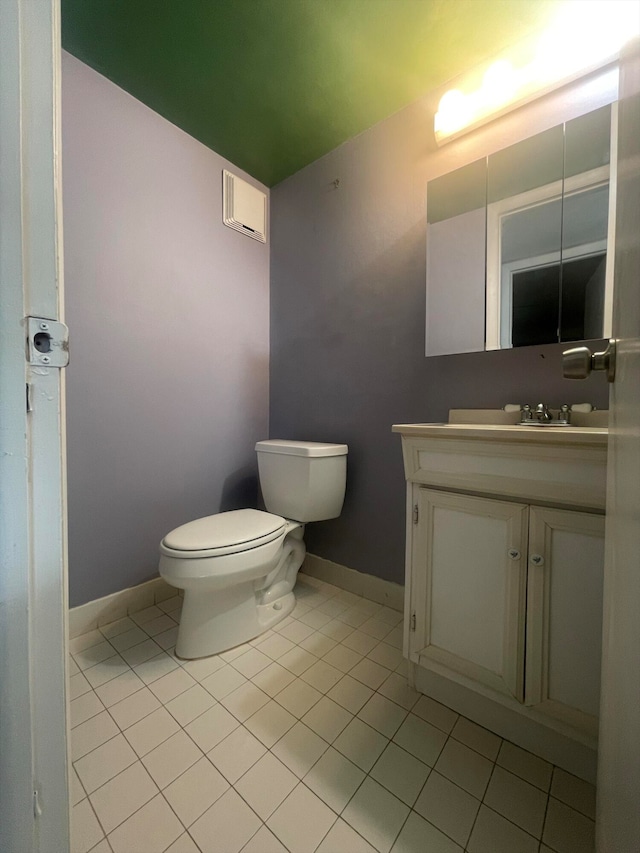 bathroom featuring toilet, tile patterned floors, and vanity