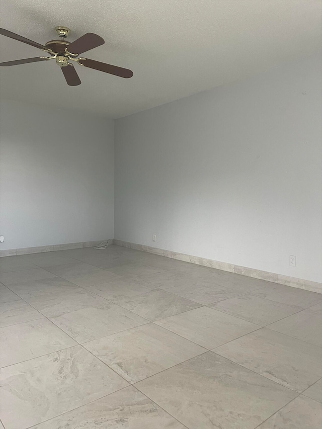 tiled empty room with ceiling fan