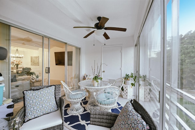 sunroom with ceiling fan with notable chandelier