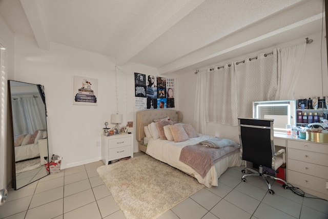 tiled bedroom featuring beamed ceiling and a textured ceiling