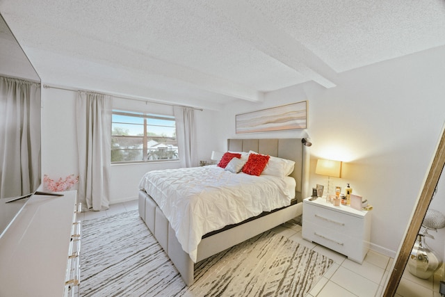 tiled bedroom featuring a textured ceiling and beamed ceiling