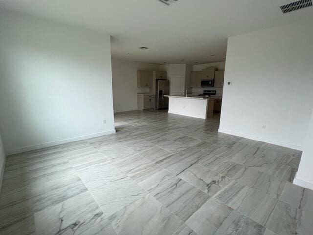 unfurnished living room with light tile patterned floors