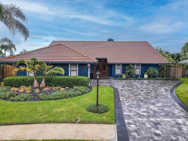 view of front of house with a yard and a garage