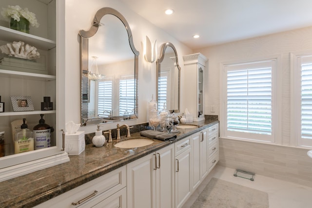 bathroom featuring tile patterned flooring, vanity, and a chandelier