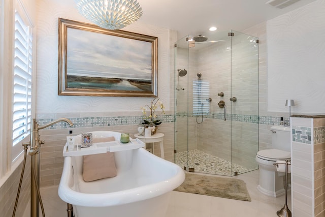 bathroom featuring a wealth of natural light and tile walls