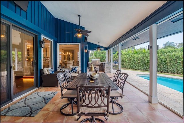 view of patio with an outdoor kitchen, a fenced in pool, and ceiling fan