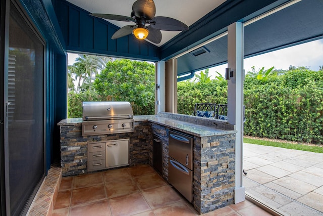 view of patio / terrace with ceiling fan, a grill, and exterior kitchen