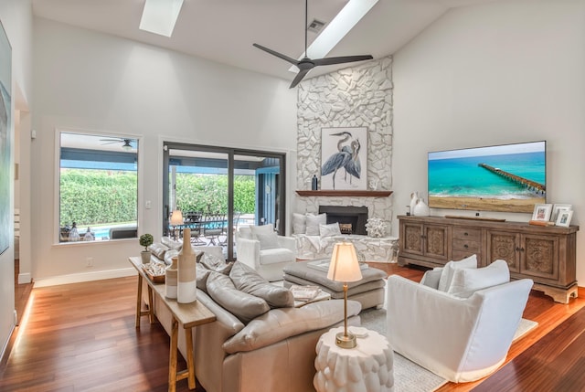 living room featuring a fireplace, high vaulted ceiling, and hardwood / wood-style floors