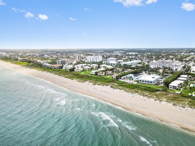 bird's eye view featuring a water view and a beach view