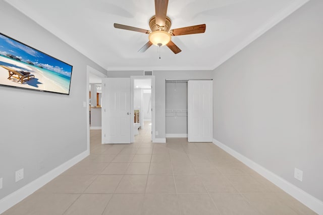 interior space featuring ceiling fan, a closet, light tile patterned flooring, and ornamental molding