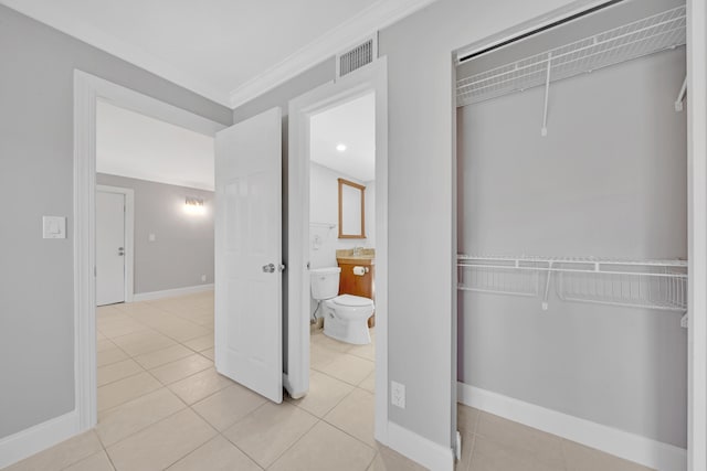 interior space featuring light tile patterned floors and crown molding