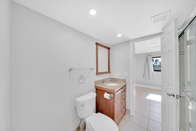 bathroom featuring toilet, vanity, and tile patterned floors