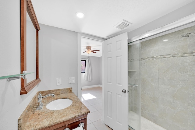 bathroom featuring tile patterned flooring, an enclosed shower, ceiling fan, and vanity