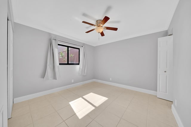 tiled spare room with ceiling fan and crown molding