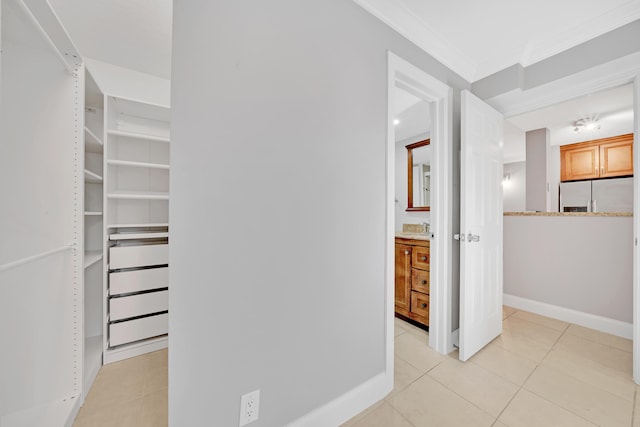 spacious closet with light tile patterned floors