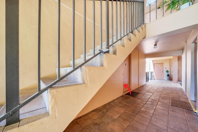 staircase with a high ceiling