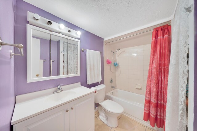 full bathroom with tile patterned floors, toilet, vanity, shower / bath combo with shower curtain, and a textured ceiling