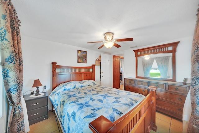 bedroom with light tile patterned floors, a ceiling fan, and visible vents