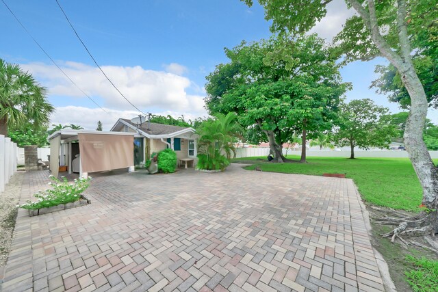 view of front of property with a front yard and a carport