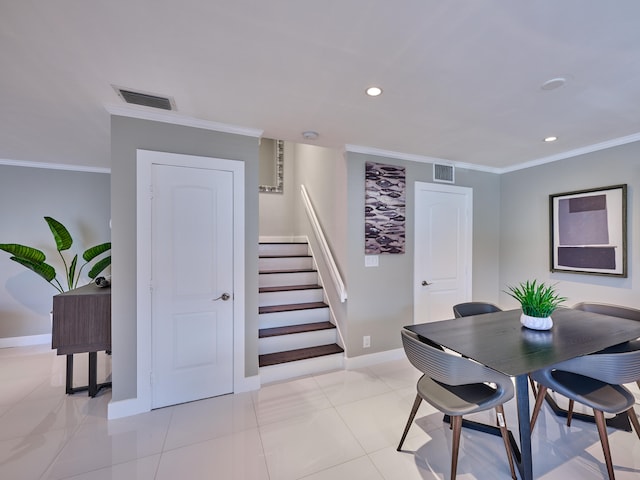 dining area with ornamental molding and light tile patterned floors