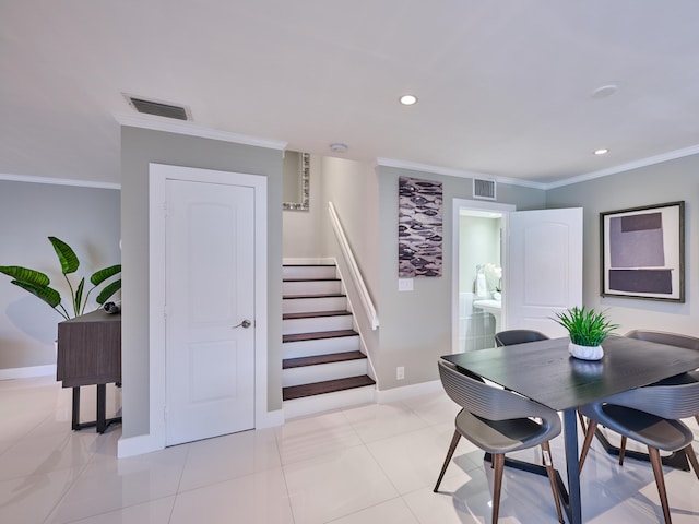 dining space featuring crown molding and light tile patterned floors