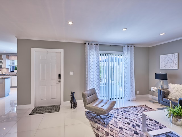 entrance foyer with ornamental molding and light tile patterned flooring