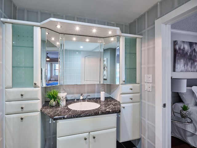 bathroom featuring vanity and ornamental molding