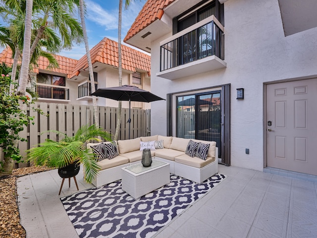 view of patio with an outdoor living space and a balcony