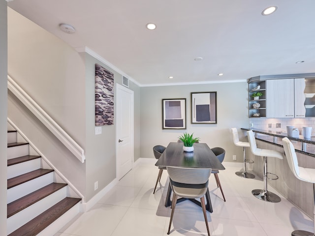 tiled dining room with ornamental molding