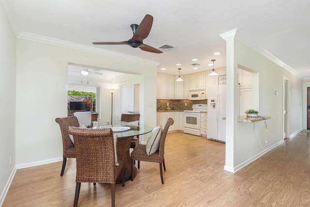 dining room with ceiling fan, ornamental molding, and light hardwood / wood-style floors