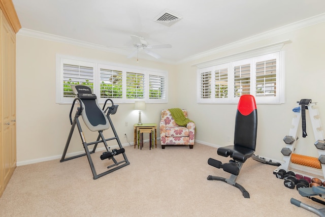 exercise room featuring ceiling fan, light carpet, and ornamental molding