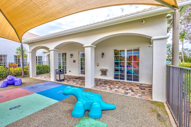 surrounding community with a patio and fence