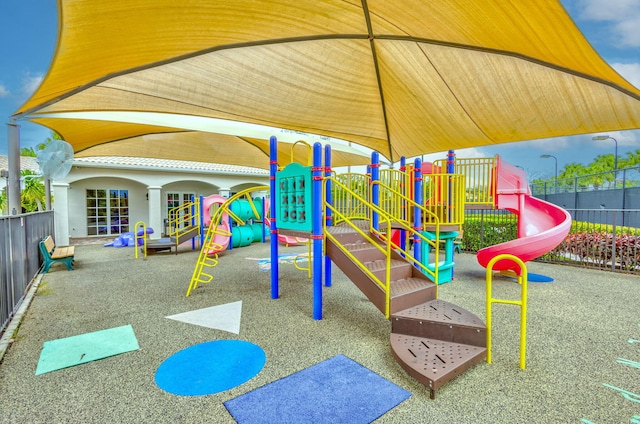 communal playground featuring fence