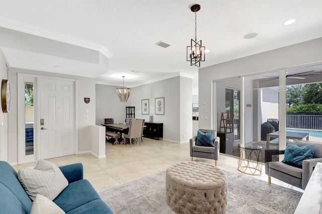 living room with crown molding, light tile patterned floors, visible vents, baseboards, and ceiling fan with notable chandelier