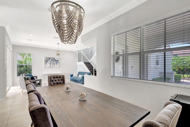 tiled dining space featuring a notable chandelier and ornamental molding