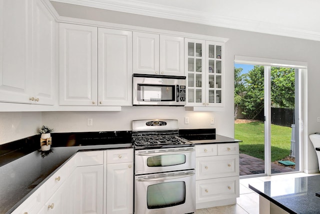 kitchen featuring stainless steel appliances, white cabinetry, and ornamental molding