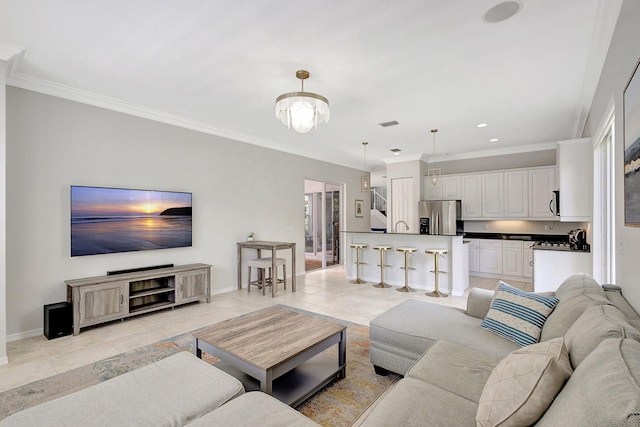 living room with ornamental molding, a chandelier, and light tile patterned flooring